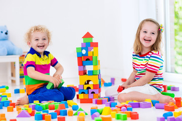 Kids playing with colorful toy blocks
