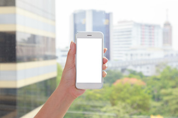 Hand holding smartphones with blurry building background