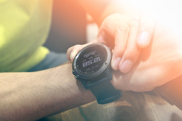 Young Man looking to watch his on wrist