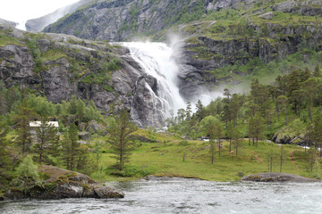 Obraz premium Waterfall in Husedalen valley in Hardangervidda national park, Norway 