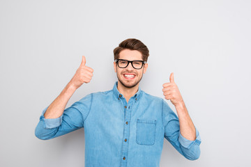 Fototapeta premium Happy smiling man in glasses showing thumbs up