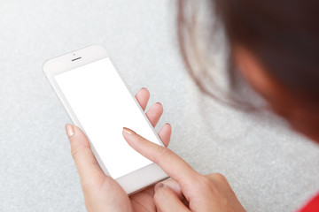 Young woman holding and using smartphone with blank white screen 