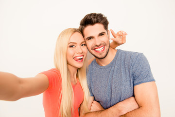 Fototapeta premium Funny selfie of man and woman in love showing tongue