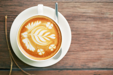 Coffee latte art cup top view on wood table background