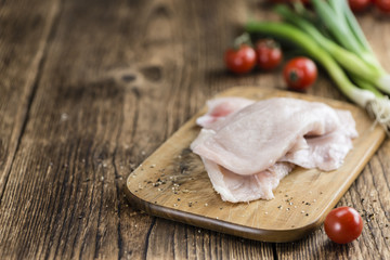 Wooden table with chicken cutlet