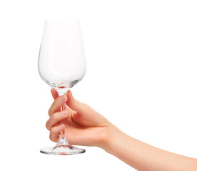 Female hand holding empty  wine glass against white
