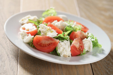 salad with tomatoes, mozzarella, rocket salad and cedar nuts