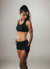 Obraz premium Pretty woman poses in her athletic shorts and top