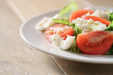 salad with tomatoes, mozzarella, rocket salad and cedar nuts