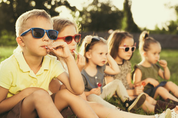 Children eating lollipops during summertime fun