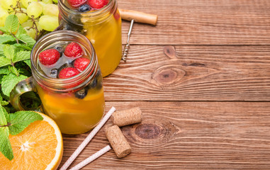 Homemade white wine sangria with fresh berries  on a wooden  table.