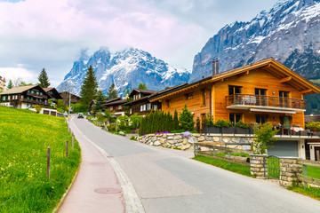 Grindelwald village scattered on the  green slopes. Switzerland 