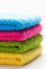 colorful, stacked bathroom towels, isolated on a white background, close up