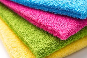 colorful stacked bathroom towels on a white background