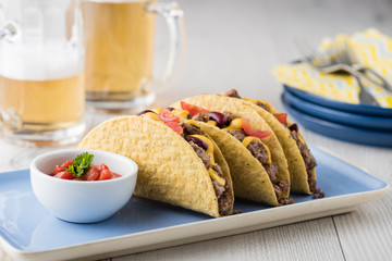 Mexican tacos with beef, cheddar cheese, tomato
