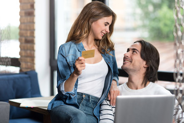 Delighted loving couple looking at each other