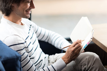 Positive man making notes