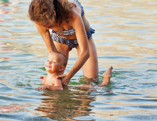 Mother and son swimming in the sea