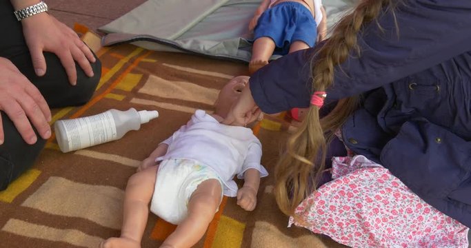 Three Training Dummies Lie Before the Little Girl