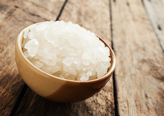 White sea salt in brown bowl in still life style