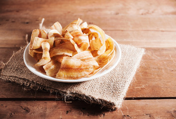 Banana chips in white plate in still life tone