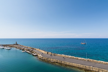 Naklejka premium KYRENIA, NORTHERN CYPRUS - MAY 2016: Stone pier in Mediterranean sea