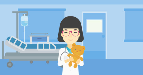 Pediatrician doctor holding teddy bear.