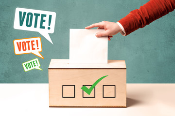 placing a voting slip into a ballot box