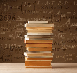 Books on vintage background with math formulas
