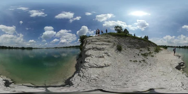 360Vr Video Man Jumps Down Into Water High Bank Of Lake Turquoise Water People Are Looking At The Man Walking By Sandy Hill Clouds Sunny Summer Day