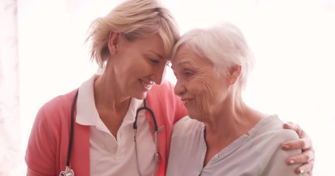 Female doctor consoling to a senior woman