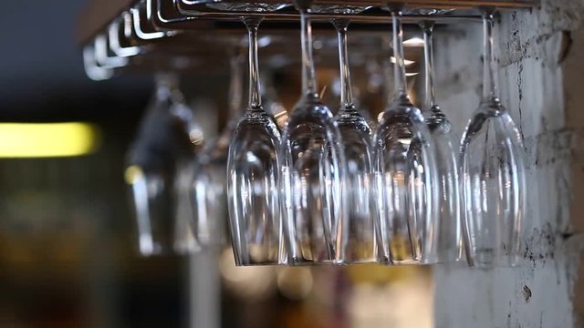 Glasses hanging upside down in cafe restaurant wine
