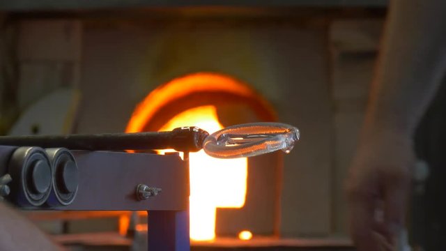 an Employee of the Plant Heats a Glass Preform With Help of a Hand Burner.