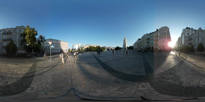 360Vr Video People on Mikhailovskaya Squre Kiev Cathedral Bell Tower on a Horizon Old Buildings Group of Cyclists Riding Through Square Pavement Sunset