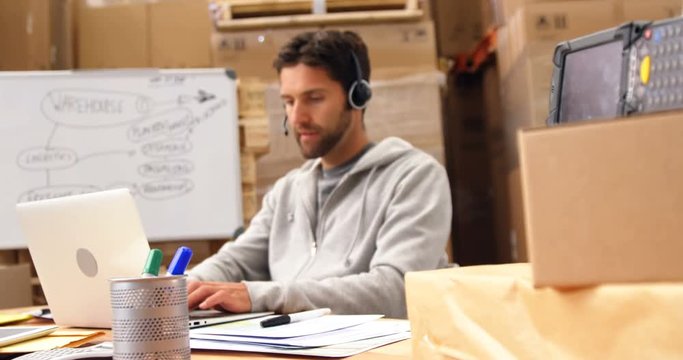 Warehouse worker using a laptop