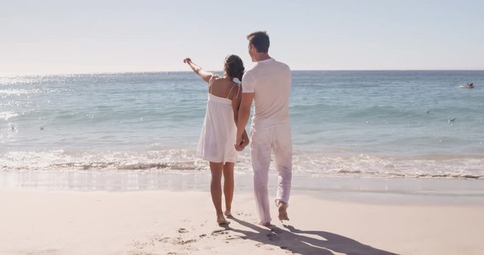 Couple walking together at the beach 