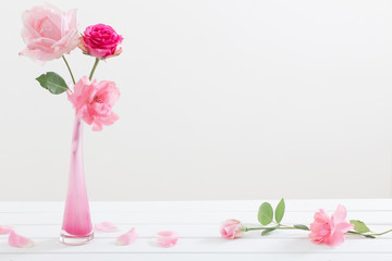Pink roses in vase  on white background