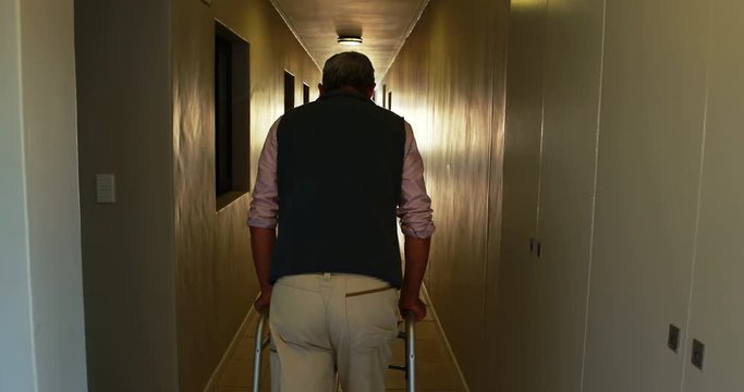  Patient walking with zimmer frame on medical office