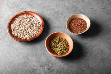 Pumpkin, linseed and sunflower seeds in bowls viewed above