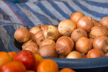 The group of onion in the tray on the table in the market