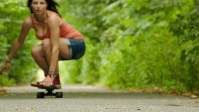 
4K. Young beautiful girl figure  goes on  skateboard
