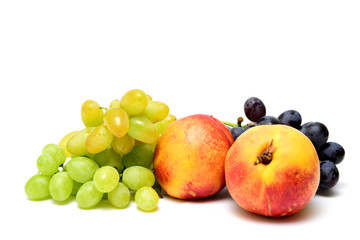 Clusters of grapes and nectarines on a white background.