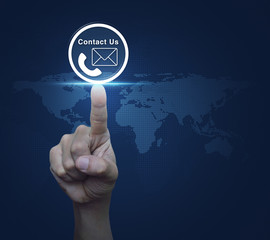 Hand pressing telephone and mail icon button over digital world