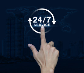 Hand pressing button 24 hours service icon over map and city tow