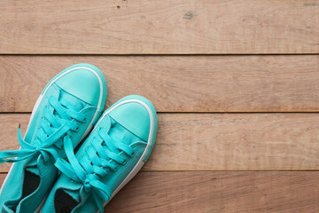 Summer holiday concept, travel items with blue canvas shoes on wooden board, flat lay, top view background