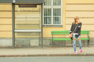 Girl waiting for a bus.