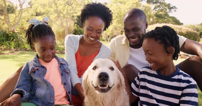Portrait of cute family is smiling and sitting with a dog 