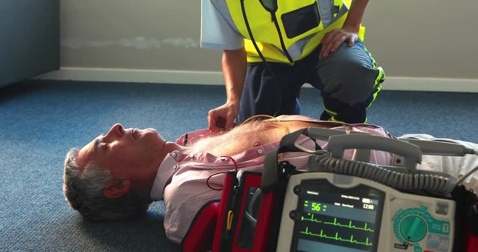 Aid woman trying to reanimate a patient in medical office 