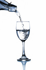 pouring water in glass on white background
