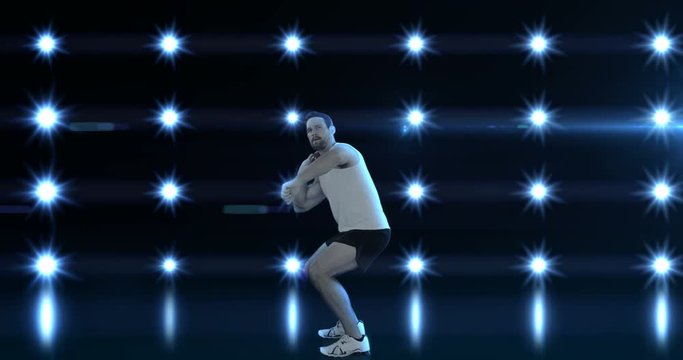 Sportsman is practising shot put against flashing light 